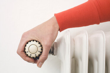 Female hand on thermostat - WESTF07513