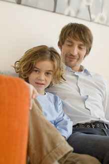 Father and son (6-7) in living room, portrait - WESTF07379