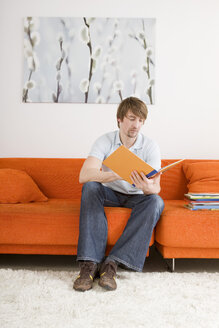 Young man reading a book - WESTF07367