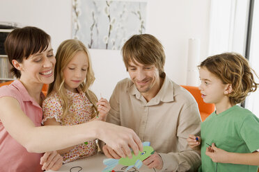 Family doing handicraft, smiling, portrait - WESTF07321