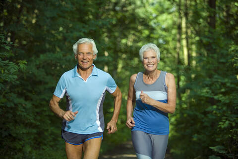 Senior couple jogging, portrait stock photo