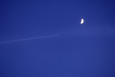 Germany, Markdorf, Airplane in the sky with half moon - SMF00315