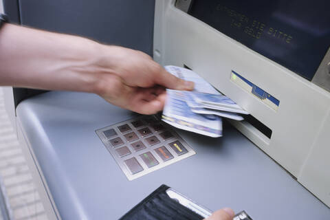 Spain, withdrawing at a cashpoint, close up stock photo