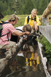 Austria, Salzburger Land, couple with son (8-9) at trough - HHF01816