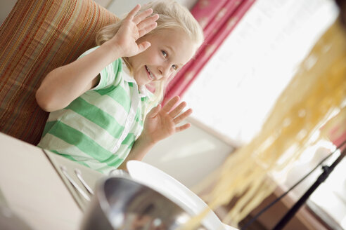 Girl (8-9) sitting at dining table - HKF00205