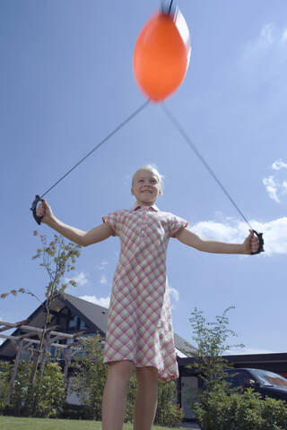 Girl (8-9) playing outside stock photo