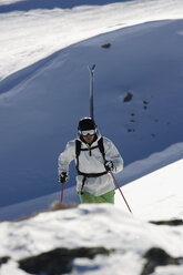 Österreich, Arlberg, Albona, Mann beim Skifahren in den Alpen - MRF01070