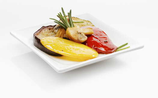 Marinated bell pepper and aubergines garnished with rosemary on plate - KMF01188