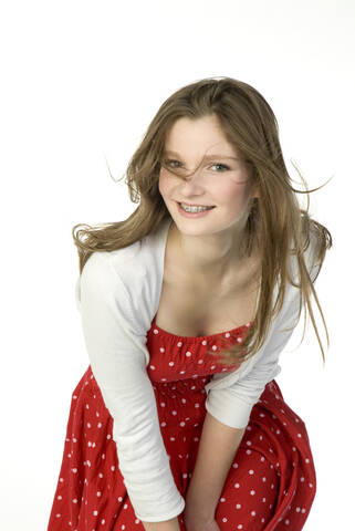 Brunette girl (13-14) in red dress, portrait stock photo