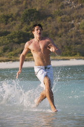 Asia, Thailand, Young man running on beach - RDF00682