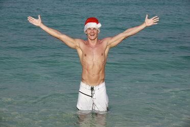 Asia, Thailand, Young man wearing santa claus cap, smiling, portrait - RDF00671