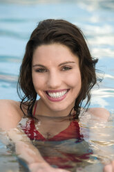 Asia, Thailand, Young woman in pool, smiling, portrait - RDF00626