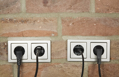 Plugs in wall socket, close-up - GWF00674