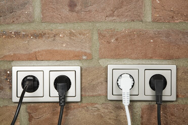 Plugs in wall socket, close-up - GWF00673
