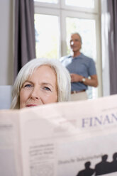 Senior woman reading a newspaper, portrait - WESTF08199