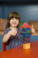 Girl (6-7) playing with building blocks, portrait - WESTF08158