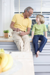 Grandfather and grandson (8-9) in the kitchen, portrait - WESTF08278