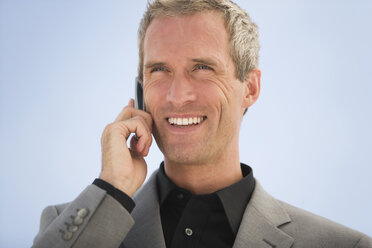 Business man using mobile phone, smiling, portrait - HKF00272