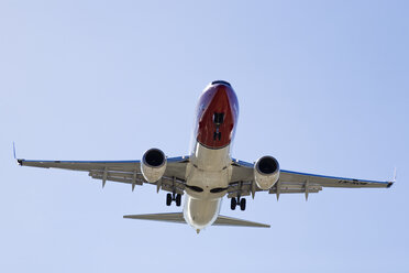 Spain, Andalusia, Malaga, Aeroplane preparing to land, low angle view - MSF02246