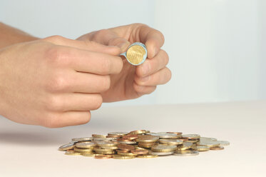 Hand holding coin roll close up stock photo