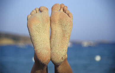 Italy, Sardinia, Tuaredda, One pair of sandy woman's feet, close-up - LFF00128