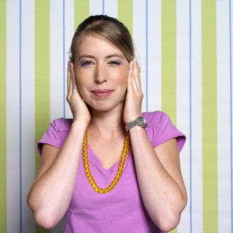 Teenage girl (16-17) covering ears, close-up, portrait - JLF00276