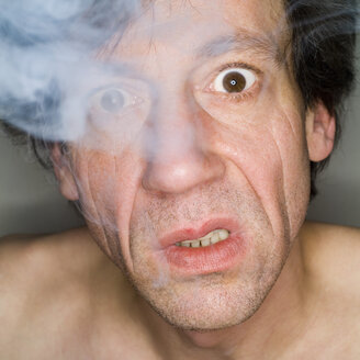 Mann beim Ausatmen von Zigarettenrauch, Nahaufnahme, Porträt - MUF00570