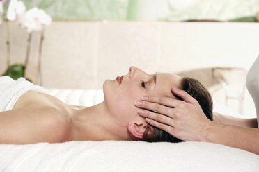 Young woman receiving facial massage, eyes closed - RDF00914