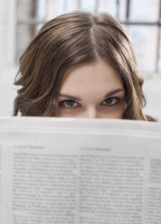 Young businesswoman holding newspaper, close-up - BMF00356