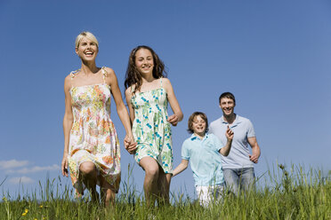 Germany, Baden Württemberg, Tübingen, Family walking in meadow - WESTF08955