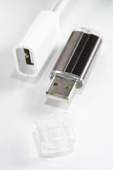 Plug and USB flash drive on white background, elevated view - JRF00043