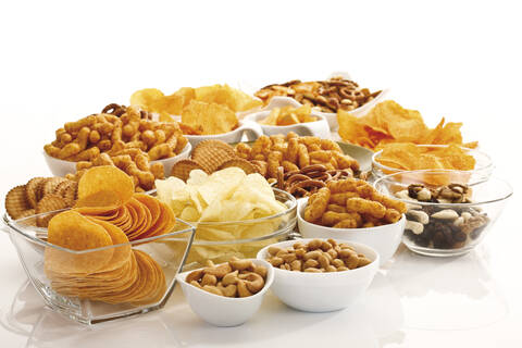 Assorted snacks in glass bowls stock photo