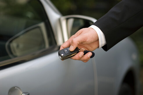 Person at car using remote control key, close-up - GAF00082