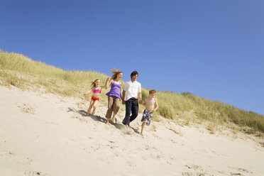 Germany, Baltic sea, Family running down sand dunes - WESTF09352