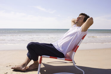 Germany, Baltic sea, Young man on beach, portrait - WESTF09254