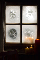 Austria, Salzburger Land, Candles burning on windowsill - HHF02678