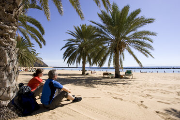 Spanien, Kanarische Inseln, Teneriffa, Pärchen entspannt am Palmenstrand - DSF00201