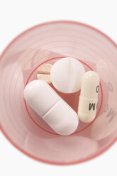 Pills in plastic cup, elevated view - THF00829