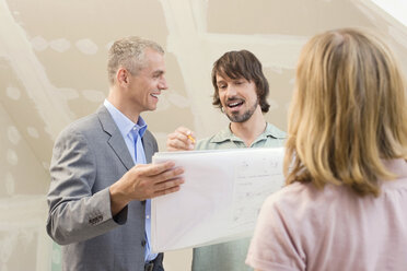 Architect discussing construction plan with young couple - WESTF09092