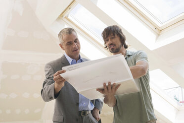 Two men looking at construction plan - WESTF08989