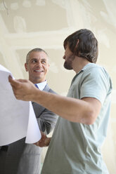 Two men looking at construction plan - WESTF08982