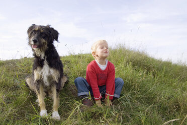 Little boy (3-4) playing with dog - SMOF00170