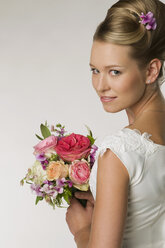 Young bride holding bridal bouquet, close-up - NHF00892