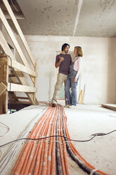 Young couple at construction site - WESTF09017