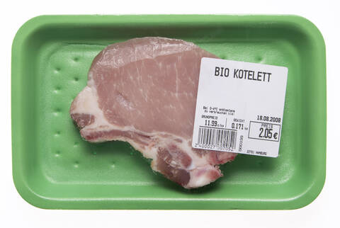 Rohes Schweinekotelett in Styroporbox, Ansicht von oben, lizenzfreies Stockfoto