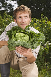 Man holding cabbage, portrait - BMF00461