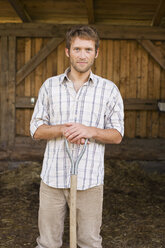 Farmer with hayfork, portrait - BMF00446