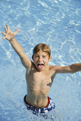 Junge (10-11), der im Schwimmbad herumalbert - TCF00941