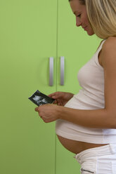 Pregnant woman holding ultrasonic picture - WESTF10043