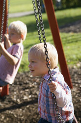 Zwei kleine Jungen ( 2-3) (4-5) sitzen auf einer Schaukel - SMO00246